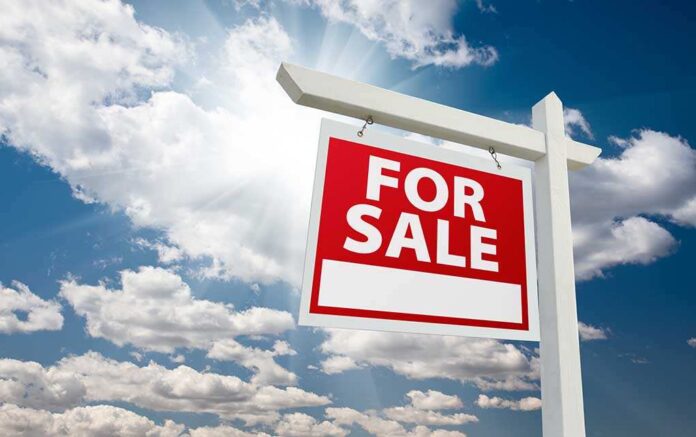 For,Sale,Real,Estate,Sign,Over,Clouds,And,Blue,Sky