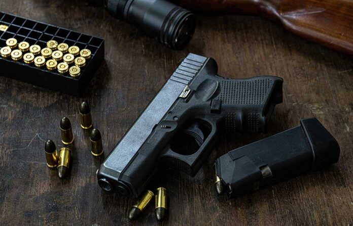 Guns,And,Ammunition,Placed,In,A,Wooden,Table,short,Guns,And