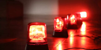 Red emergency lights on a dark floor