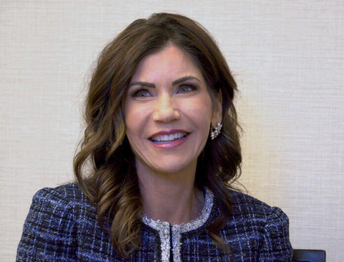 shutterstock_1962517687.jpg featured image Gov Kristi Noem smiling indoors.