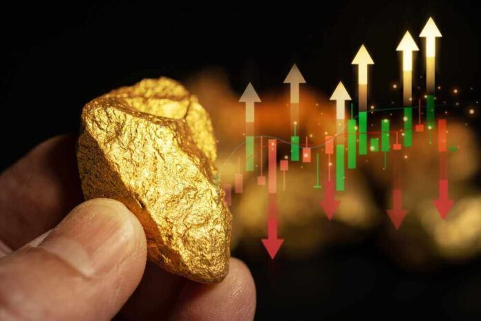 shutterstock_2338181603.jpg featured image Hand holding gold nugget with financial market chart.