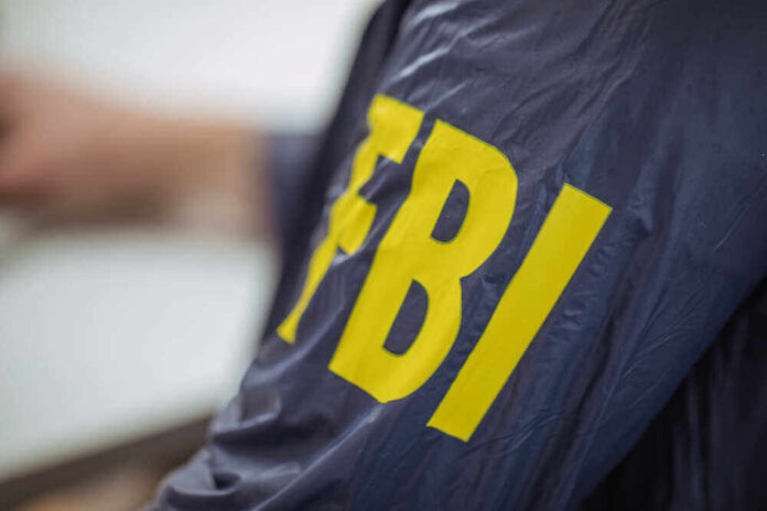 shutterstock_612694196.jpg featured image Person wearing FBI jacket, letters in yellow.