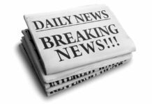 Stack of newspapers with breaking news headline