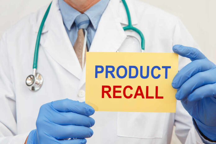 shutterstock_1849024102.jpg featured image Doctor holding a product recall sign in gloves