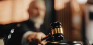 Judge striking gavel in courtroom.