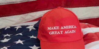 Red Make America Great Again hat on American flag