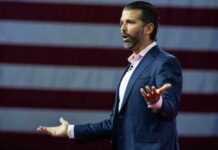 Donald Trump Jr. speaking, American flag.