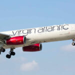 Virgin Atlantic plane flying in clear blue sky