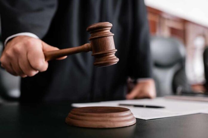 shutterstock_2121705137.jpg featured image Judge holding gavel in courtroom.