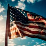 American flag waving against a bright sky.
