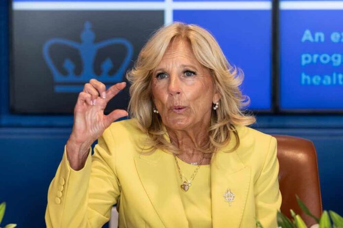 shutterstock_2330921007.jpg featured image Jill Biden yellow speaking and gesturing with hand