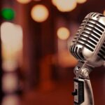 Retro microphone with blurred background lights.