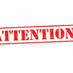 FBI, DHS Warn of ‘Elevated Threat’ Red attention stamp on white background