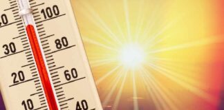 Thermometer shows high temperature under scorching sun.