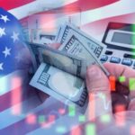 Top Banker Issues URGENT Economic Warning USA flag calculator and hands holding dollars overlapping