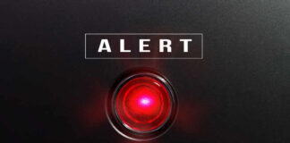 Red alert light on black background