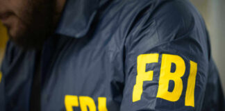 FBI agent in navy blue jacket.