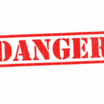 Red danger stamp on white background