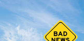 Yellow sign reads bad news in sky