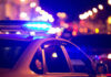 Police car with flashing blue lights at night