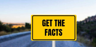 Yellow sign reads Get the Facts on road