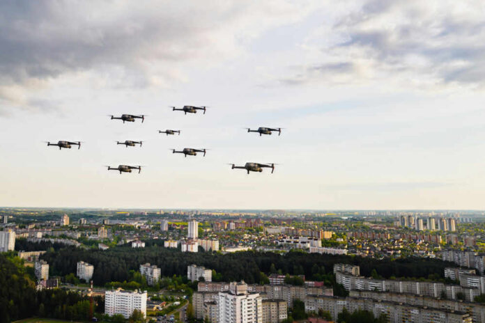 Drones flying over a cityscape under cloudy sky