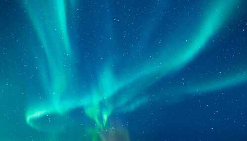 shutterstock_2571516009.jpg Vibrant northern lights dancing across a starry night sky