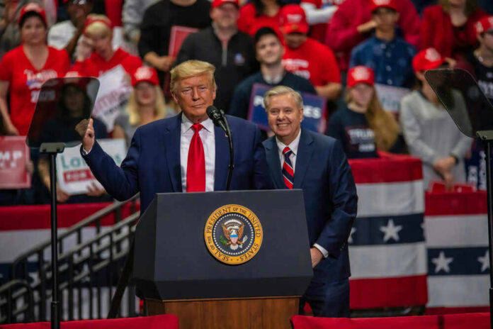 Two men speak at a political rally.