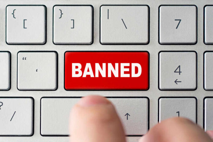 Red banned key on computer keyboard pressed