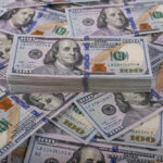 Banking Giant’s SHOCK Move Stack of one hundred dollar bills, Benjamin Franklins portrait.