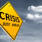 Famous Food Chain CRUMBLES — Private Equity to Blame? A yellow warning sign indicating a crisis ahead