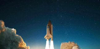 Space shuttle launching into a starry night sky.