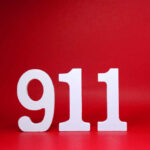 White numbers 911 on a red background