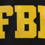 NEWS ALERT: FBI Investigating NFL Owner’s Death FBI logo displayed in large yellow letters on a black background