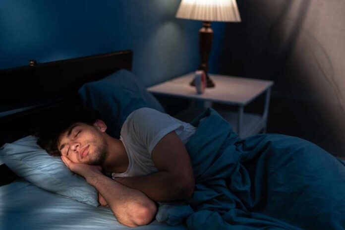 A young man sleeping peacefully in a dimly lit bedroom
