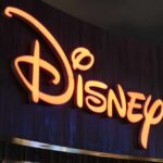 Disney Era Ends: Animation Icon’s Death Stuns Fans Illuminated Disney logo against a dark background