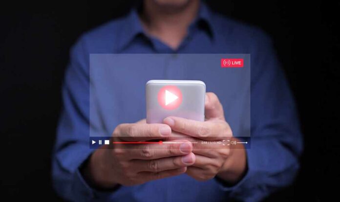 Person holding a smartphone with a live streaming interface