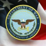 Senator Sues War Chief: Military Retaliation Shocker Emblem of the Department of War on a background of the American flag
