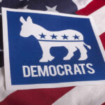 Top Democrat RETIRES — Major Political Battle Looms Democratic Party logo on American flag background.