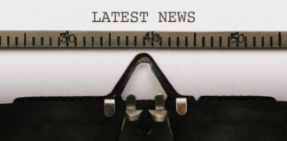 Close-up of a typewriter with a sheet of paper displaying the words 'LATEST NEWS'
