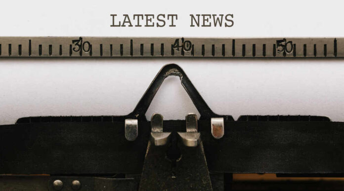 Close-up of a typewriter with a sheet of paper displaying the words 'LATEST NEWS'
