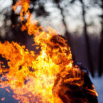 Deadly Ski Resort Fire Uncovers SHOCKING Negligence A silhouette of a person engulfed in flames in a forest setting
