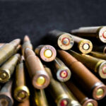 Dad Knew About Shooter Shrine — Gave Gun Anyway Close-up of assorted rifle bullets on a dark background.