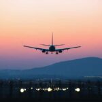 Mid-Air Engine Failure — Crisis Closes Airport An airplane approaching for landing against a colorful sunset sky