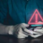 Affair Text Bombshell Hits GOP Congressman Person holding phone with warning symbol displayed.
