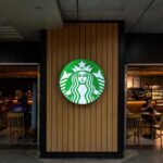 Starbucks coffee shop entrance with logo and customers inside