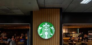 Starbucks coffee shop entrance with logo and customers inside