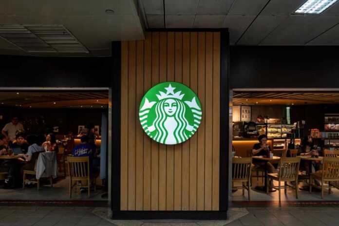 Starbucks coffee shop entrance with logo and customers inside