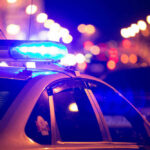 VIDEO: Trans Father Executes Family During Son’s Game Police car with flashing blue lights at night.