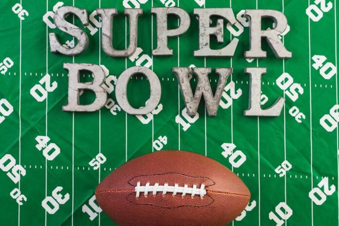 A football and the words 'SUPER BOWL' on a green football field background